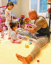 the rock with his daughter